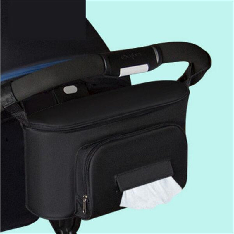 Black organizer attached to stroller handle. Stroller not included.